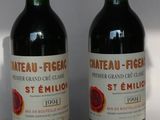 two bottles of wine sitting next to each other on a table