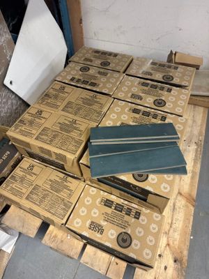 a pile of boxes on top of a pallet of wood