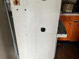 an image of a refrigerator in a room with a lot of clutter