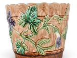 an image of a planter with flowers and leaves on it