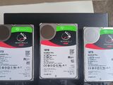 three hard drives sitting on top of a black box next to each other