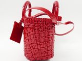 the small red basket bag has a tag attached to it