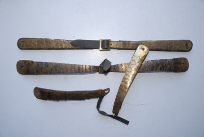 three knives are laying on a white surface with a black handle