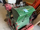 a small engine sitting on top of a pallet in a garage