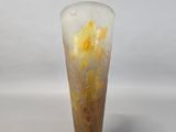 a glass vase with yellow flowers in it on a white surface