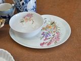 a plate with a bowl and a plate with a bowl and a cup on it