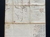 an old piece of paper with writing on it sitting on a table