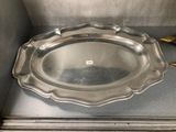 a silver plate on a counter with a pair of scissors