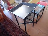 a ping - pong table and two stools in a living room