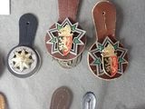 a lot of badges on a table next to a pair of flip flops