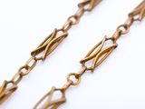 gold plated brass chain with long links on a white background