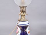 a blue and white lamp with a glass shade on it