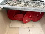 a box with a bunch of red hoses inside of it