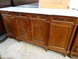 a wooden cabinet with a marble top in a room