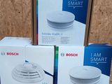 three boxes of bosch smoke detector sitting on top of a table