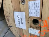a wooden spool with a sticker on it