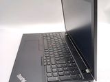 a black laptop with a black keyboard on a white table