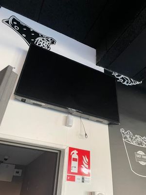 a flat screen tv mounted on the wall above a door
