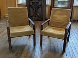 two chairs that are sitting in the middle of a room