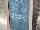 a chalk board with writing on it hanging from a hook