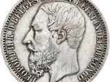Gros plan sur une pièce de monnaie portant le visage d'un homme