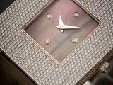 an image of a close up of a watch with diamonds on the face