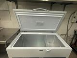 a white chest freezer sitting in a kitchen