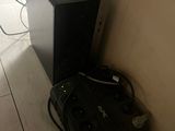 a black computer sitting on the floor next to a bag