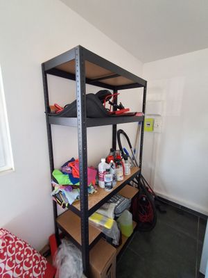 a shelf that has many items on it in a room