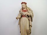 an old statue of a woman holding a baby in her arms