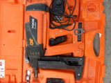 an orange tool case with a stapler, stapler, and stapler in it