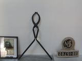 a clock on the wall next to a picture and a clock on the floor