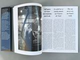 an open book with a picture of a man in a factory