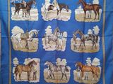 a blue table cloth with a picture of horses on it