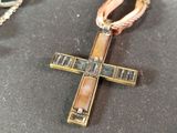 a cross that is sitting on a table next to a pair of scissors