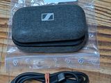 a black case and a charger on a wooden table