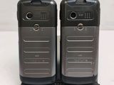 two cell phones that are sitting on a stand