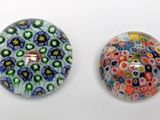 two glass beads that are sitting on a table