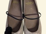 a pair of shoes with a pom - pom on them