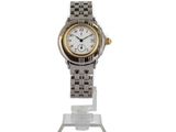 a silver and gold wrist watch on a clear stand