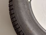 a tire that is sitting on a white surface