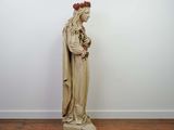 a statue of a woman holding a flower in her hands