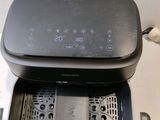 an air fryer sitting on top of a counter next to a toaster oven