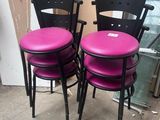 pair of black and pink metal chairs with pink cushions