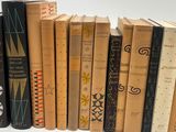 books are lined up in a row on a white surface