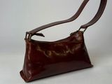 brown leather handbag on white background with brown strap