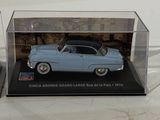 two model cars in a display case on a table