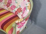 a chair with a colorful striped cushion on it in a room