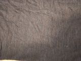 a close up of a black shirt with a small hole in the back