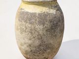 a large clay pot sitting on a white surface